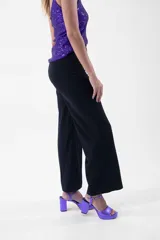 Pantalón negro de corte palazzo con lazo en la cintura.