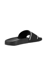 Ojotas Calvin Klein negras con logo "CK" en relieve blanco en la tira.