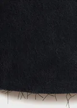 Pantalón de jean negro de corte wide leg, con tiro alto, cinco bolsillos, trabillas y bajo deshilachado.