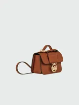 Bandolera Longchamp modelo Box-Trot XS, color amarillo, con correa fina ajustable y logo circular en el frente.