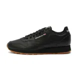 Championes Reebok Classic Leather negros de cuero con suela de goma color caramelo.