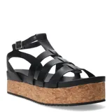 Sandalias franciscanas de cuero negro con plataforma plana de corcho y tiras entrecruzadas.