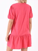 Vestido corto fucsia con mangas cortas abullonadas y falda con volantes.