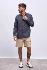 Camisa celeste a rayas verticales blancas, de manga larga y corte clásico.