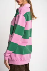Sweater de algodón peinado a rayas horizontales rosas y verdes, con cuello polo y cierre parcial con botones.