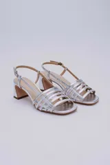 Sandalias negras de cuero con tiras finas entrecruzadas y taco geométrico.