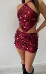 Conjunto de top halter y minifalda tiro bajo, ambos cubiertos de lentejuelas color borgoña.