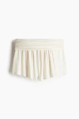 Short color crudo de punto acanalado fino de viscosa, con cintura ancha y costuras laterales fruncidas que crean un efecto drapeado.