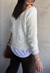 Sweater color natural de tejido de punto con cuello redondo y mangas largas. Corte clásico y textura suave.