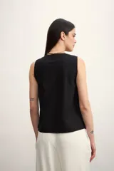 Chaleco negro con escote en V y abotonadura frontal.