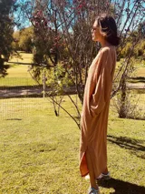 Vestido largo de lanilla color tostado, con diseño acanalado y corte holgado.