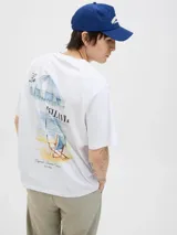 Remera blanca de algodón con cuello redondo y mangas cortas. Estampado en la espalda con una sombrilla de playa, una reposera y la frase "Bella Vita".