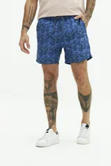 Short de baño azul con estampado de hojas, cintura elástica con cordón ajustable, dos bolsillos laterales y uno trasero.
