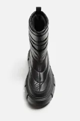 Bota corta color verde militar con diseño acolchado, tirador trasero y suela track negra.