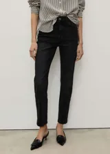 Pantalón de jean negro, tiro alto, corte mom fit, con cinco bolsillos y cierre de cremallera y botón.