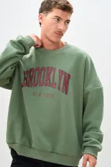 Buzo verde oliva con estampa en el frente con la palabra "Brooklyn" en color bordó y la frase "New York" en color gris.