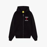 Campera negra con capucha, corte oversize y estampado de corazón roto con texto en la espalda. Incluye un sticker amarillo con texto manuscrito.