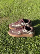 Zapatillas bajas color verde militar de gamuza con suela marrón y detalle trasero en color crema.