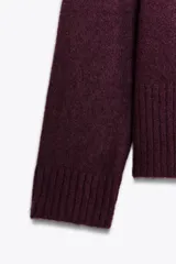 Sweater de punto color borgoña con escote en V y mangas largas.