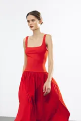 Vestido midi rojo de escote cuadrado y tirantes anchos. Detalle de bajo redondeado en tejido combinado a tono.