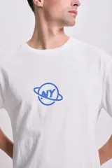 Remera blanca de corte oversize con estampado de un planeta con las letras 'NY' en color azul.