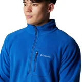Polar de hombre Columbia Fast Trek III, color azul brillante, con cuello alto y cierre frontal parcial (half-zip). Presenta un bolsillo con cierre en el pecho.
