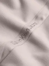 Pantalón de chándal en color rosa, confeccionado con tejido reciclado y con cintura elástica, puños ajustados y logo de Calvin Klein en los laterales.