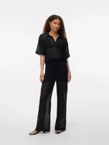 Pantalón negro de punto single jersey con corte wide leg, tiro alto y cintura elástica con cordón ajustable.