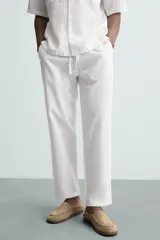Pantalón azul marino de corte recto, con cintura elástica ajustable con cordón, bolsillos laterales y traseros.