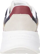 Zapatillas Tommy Hilfiger estilo running con suela gruesa, diseño color block en azul marino, beige y blanco, detalles distintivos metálicos y logo dorado en la lengüeta.