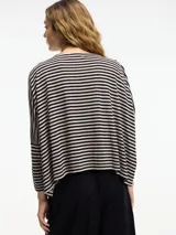 Remera amplia a rayas horizontales negras y beige, de mangas 3/4 y cuello redondo.