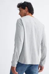 Remera manga larga gris claro melange con cuello redondo y botones.