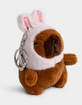 Llavero de peluche con forma de capibara disfrazada de conejo, con detalles en rosa y marrón. Incluye gancho metálico para colgar en carteras, mochilas o bolsos.