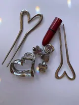 Pinza dorada para el pelo con detalle en forma de corazón.