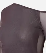Blusa de manga larga confeccionada en tule color marrón con estampado abstracto. Presenta escote asimétrico, transparencia en mangas y espalda, fruncido lateral y bajo asimétrico.