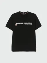 Remera negra de algodón con estampado frontal de la marca Moncler Grenoble en color blanco.