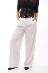 Pantalón de vestir color blanco, de corte palazzo y tiro alto.