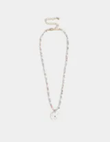 Collar corto de cuentas blancas, celestes y rosadas, con dije de flor blanca con centro azul, dije de caracol y dije de corazón dorado.