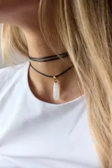 Gargantilla doble con choker de cuero negro y collar con dije de piedra natural marrón en forma de gota con engarce de acero quirúrgico hipoalergénico y tiento negro.