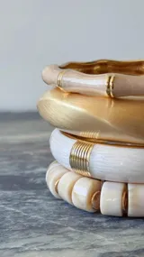 Pulsera rígida esmaltada color dorado, beige y blanco.