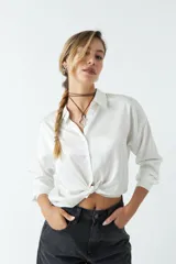 Camisa blanca de satén con corte relajado y largo a la cadera.