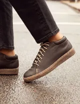 Zapatillas acordonadas de cuero color chocolate oscuro, con suela cosida y cordones color crema.