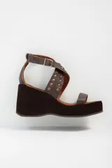 Sandalias negras con plataforma y taco de cuña, tiras de cuero con apliques de tachas plateadas y hebilla lateral.