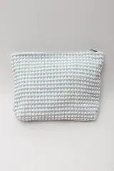 Neceser rectangular con cierre superior, confeccionado en tejido de toalla con diseño a cuadros en color celeste y blanco.