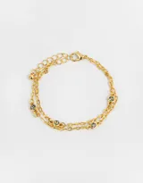 Pulsera dorada de doble cadena con eslabones y dijes de piedras de fantasía redondas con efecto tornasol.