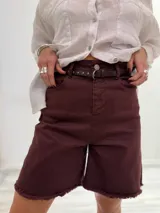 Bermuda marrón de gabardina elastizada con cinturón fino con tachas y detalles de flecos en el ruedo.