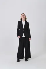 Blazer negro de poliéster, entallado, con cuello solapa y un botón frontal.