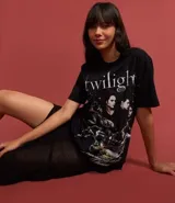 Remera negra de algodón con cuello redondo y manga corta. Presenta un estampado gráfico de la saga 'Twilight' con varios personajes y el texto 'I dream about being with you forever'.