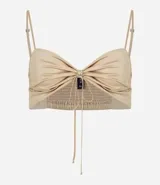 Blusa cropped satinada color dorado, con breteles finos y lazo en el escote.