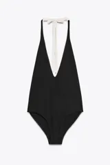 Bañador negro con escote pronunciado en V, cuello halter con lazo blanco y forro interior.